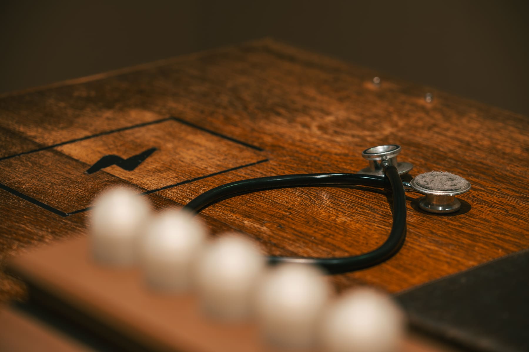 A stethoscope resting on a wooden work surface inside Memories of Nikola.